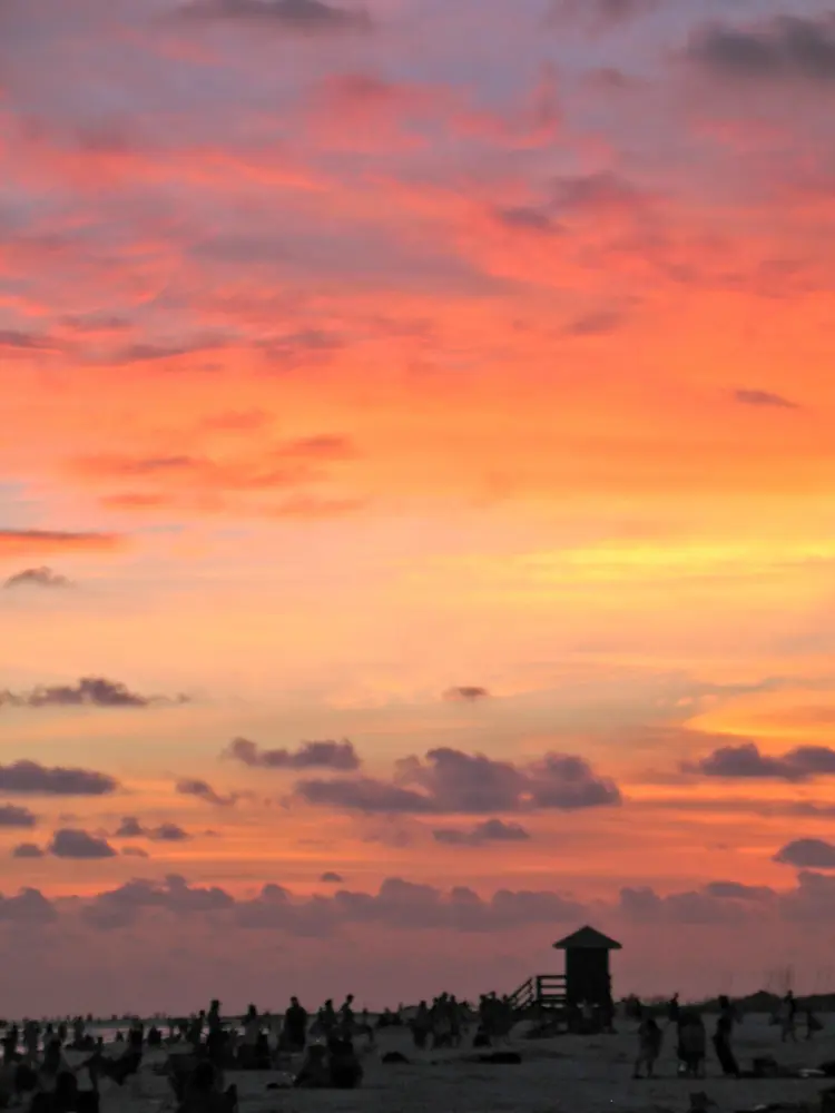 Orange sunset over Siesta Beach, home of the Sunday drum circle